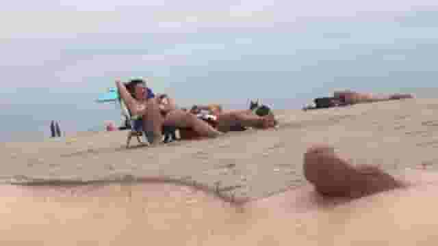 Guy pretends to be asleep on the beach while people watch him cum 2