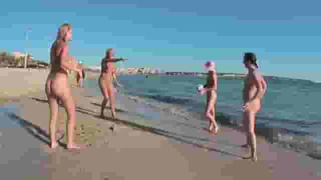 4 nude girls playing ball on a non-nude beach