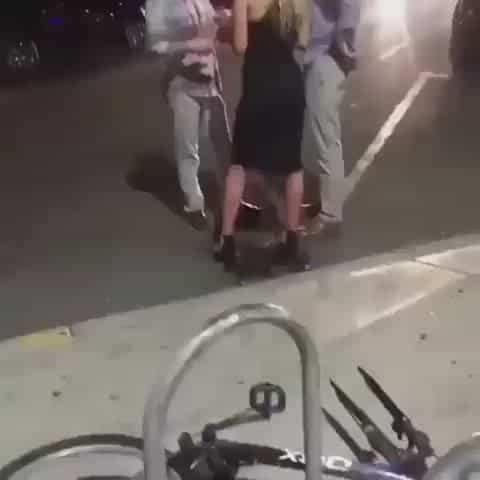 Pissing in the street like a dog while talking to two people